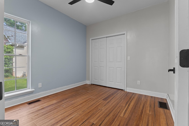 1133 Stone Brook Ln, Bremen, GA 30110 - unfurnished bedroom with multiple windows, wood finished floors, and baseboards