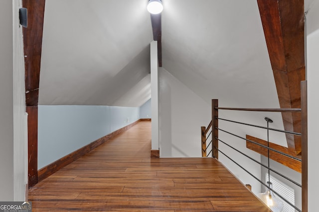 1133 Stone Brook Ln, Bremen, GA 30110 - corridor with hardwood / wood-style flooring, an upstairs landing, vaulted ceiling, and baseboards