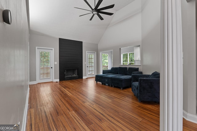 1133 Stone Brook Ln, Bremen, GA 30110 - living area featuring ceiling fan, wood finished floors, high vaulted ceiling, a large fireplace, and baseboards