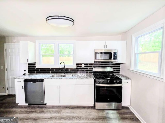 2190 Gordon Cir SE, Smyrna, GA 30080 - kitchen featuring appliances with stainless steel finishes, a sink, dark wood finished floors, and light stone counters