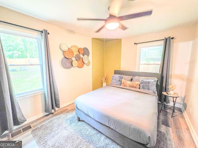 2190 Gordon Cir SE, Smyrna, GA 30080 - bedroom featuring multiple windows, wood finished floors, baseboards, and a ceiling fan