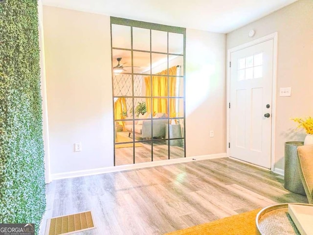 2190 Gordon Cir SE, Smyrna, GA 30080 - foyer entrance featuring wood finished floors, baseboards, and ceiling fan