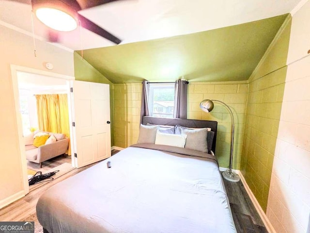 2190 Gordon Cir SE, Smyrna, GA 30080 - bedroom featuring vaulted ceiling, wood finished floors, and tile walls