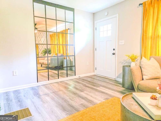 2190 Gordon Cir SE, Smyrna, GA 30080 - foyer entrance with wood finished floors, baseboards, and ceiling fan