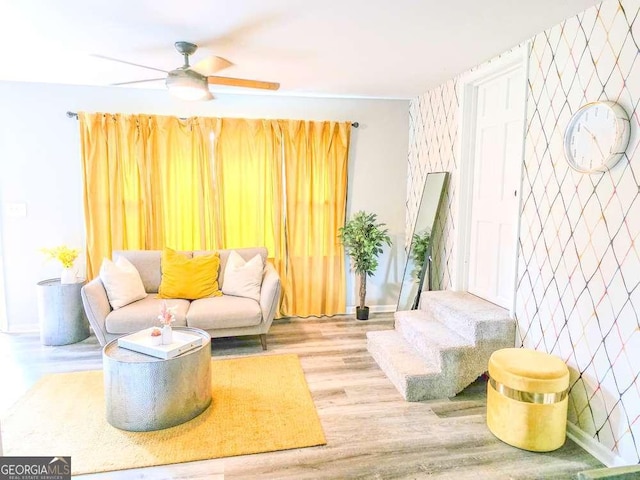 2190 Gordon Cir SE, Smyrna, GA 30080 - living area with a ceiling fan, wood finished floors, baseboards, and an accent wall