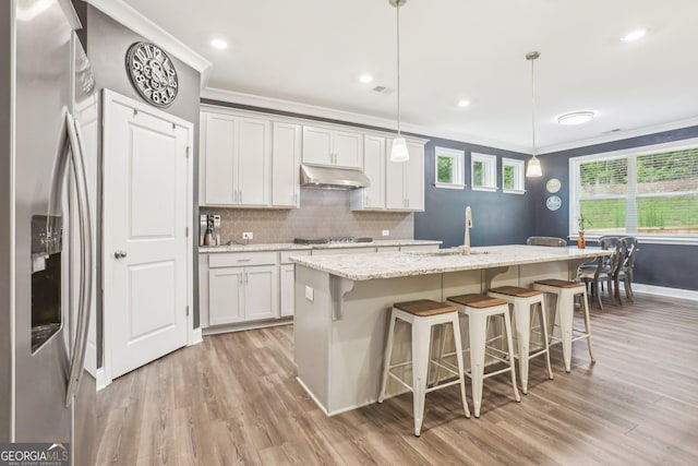 160 Amherst Way, Fayetteville, GA 30215 - kitchen featuring stainless steel refrigerator with ice dispenser, under cabinet range hood, a sink, crown molding, and light wood-style floors