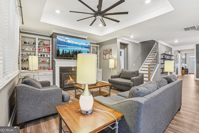 160 Amherst Way, Fayetteville, GA 30215 - living area featuring a tray ceiling, ceiling fan, stairs, wood finished floors, and recessed lighting