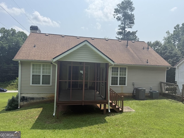 650 Flippen Rd, Stockbridge, GA 30281 - rear view of house with a sunroom, a chimney, a lawn, and a shingled roof