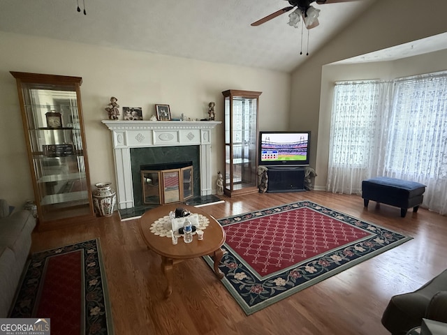 650 Flippen Rd, Stockbridge, GA 30281 - living area featuring ceiling fan, wood finished floors, vaulted ceiling, and a glass covered fireplace