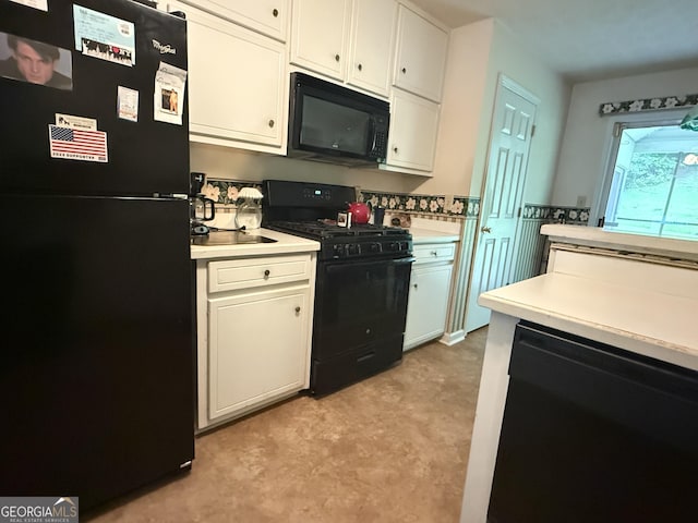 650 Flippen Rd, Stockbridge, GA 30281 - kitchen with black appliances, light countertops, and white cabinets