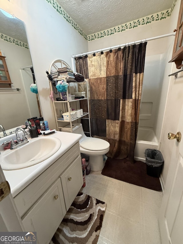 650 Flippen Rd, Stockbridge, GA 30281 - bathroom with a textured ceiling, vanity, tile patterned floors, and shower / bath combo with shower curtain