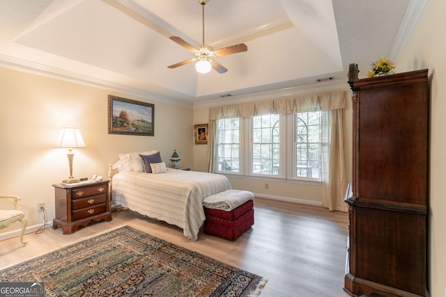 1115 Hunters Creek Ct, Lawrenceville, GA 30043 - bedroom with a tray ceiling, wood finished floors, ornamental molding, baseboards, and ceiling fan