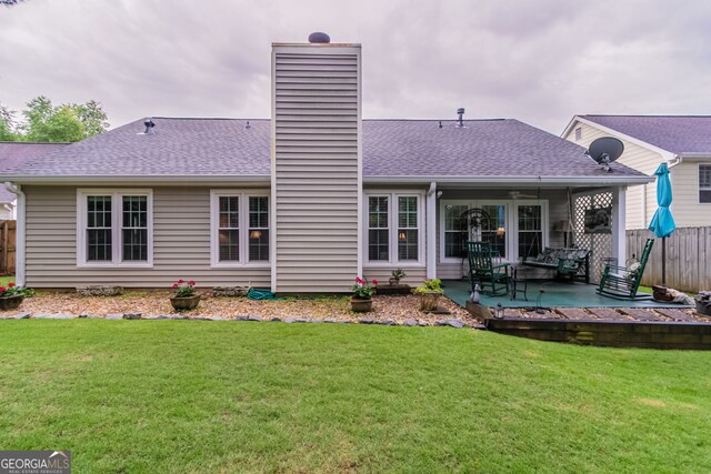 1115 Hunters Creek Ct, Lawrenceville, GA 30043 - back of house featuring a chimney, a patio area, and a shingled roof
