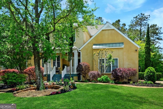 180 Shadow Wood Bnd, Saint Simons, GA 31522 - view of front of property with stucco siding, a front lawn, covered porch, and a standing seam roof