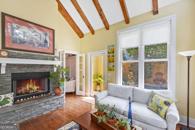 180 Shadow Wood Bnd, Saint Simons, GA 31522 - living area featuring wood finished floors, beamed ceiling, a stone fireplace, and high vaulted ceiling