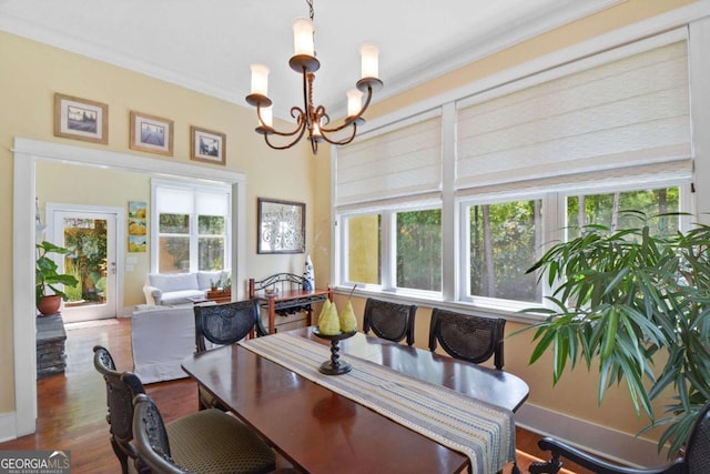 180 Shadow Wood Bnd, Saint Simons, GA 31522 - dining area with a chandelier, healthy amount of natural light, wood finished floors, and crown molding