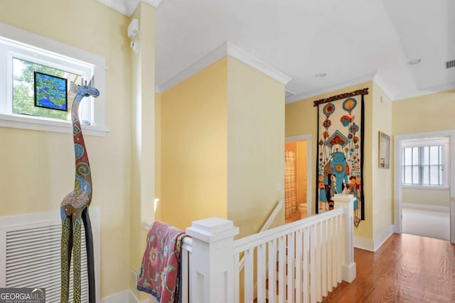 180 Shadow Wood Bnd, Saint Simons, GA 31522 - corridor with an upstairs landing, wood finished floors, and crown molding