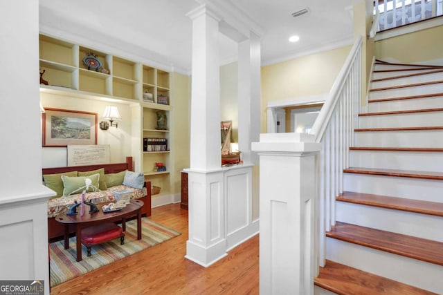180 Shadow Wood Bnd, Saint Simons, GA 31522 - stairs featuring wood finished floors, built in features, crown molding, and ornate columns