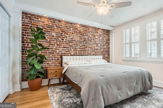 1078 Piedmont Ave NE Unit 206, Atlanta, GA 30309 - bedroom featuring brick wall, multiple windows, light wood-style flooring, ceiling fan, and crown molding