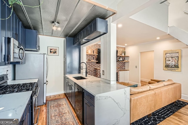 1078 Piedmont Ave NE Unit 206, Atlanta, GA 30309 - kitchen with appliances with stainless steel finishes, light wood-style floors, light stone counters, open floor plan, and tasteful backsplash