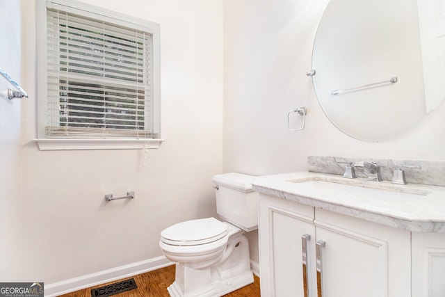 2330 Springmonte Pl, Cumming, GA 30041 - half bath with vanity, wood finished floors, baseboards, and toilet
