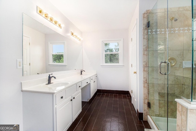 2330 Springmonte Pl, Cumming, GA 30041 - full bathroom with double vanity, healthy amount of natural light, baseboards, and a stall shower