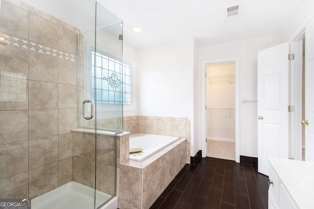 2330 Springmonte Pl, Cumming, GA 30041 - bathroom featuring a shower stall, a garden tub, vanity, a walk in closet, and recessed lighting