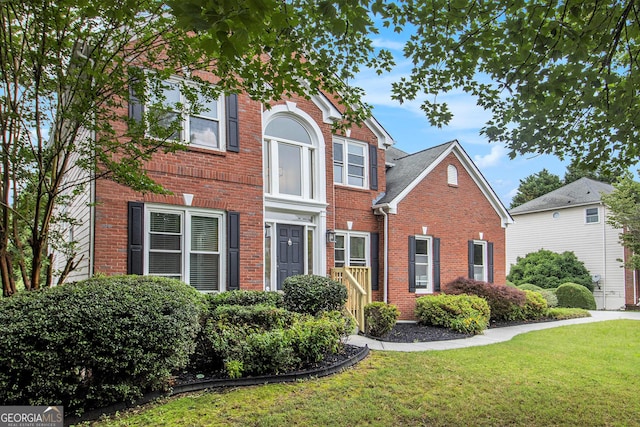 2330 Springmonte Pl, Cumming, GA 30041 - traditional-style home with brick siding and a front lawn