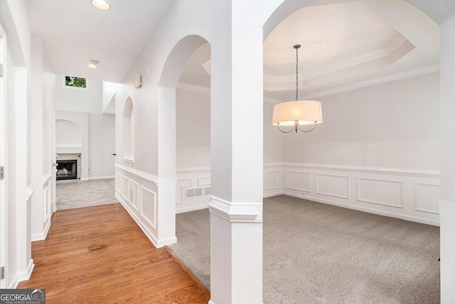 2330 Springmonte Pl, Cumming, GA 30041 - hallway featuring a decorative wall, crown molding, wainscoting, recessed lighting, and arched walkways