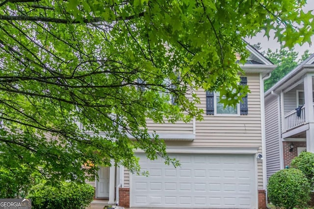 541 Shadow Valley Ct, Lithonia, GA 30058 - obstructed view of property featuring a garage, brick siding, and driveway