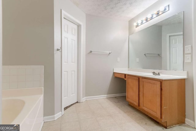 541 Shadow Valley Ct, Lithonia, GA 30058 - bathroom featuring vanity, a garden tub, baseboards, and a textured ceiling