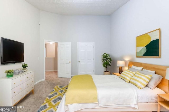 541 Shadow Valley Ct, Lithonia, GA 30058 - bedroom featuring light carpet, a towering ceiling, and baseboards