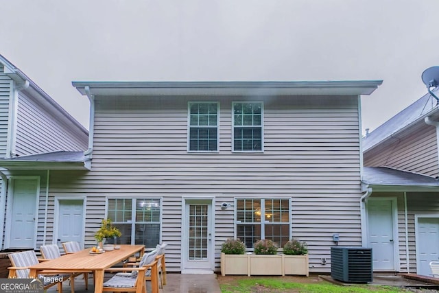 541 Shadow Valley Ct, Lithonia, GA 30058 - back of house featuring central AC, outdoor dining area, and a patio