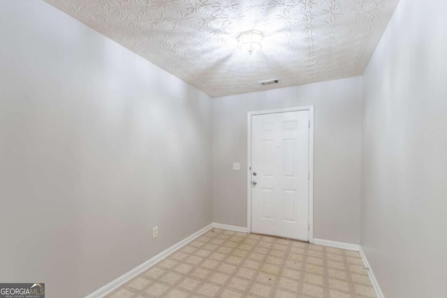 541 Shadow Valley Ct, Lithonia, GA 30058 - unfurnished room featuring light floors, baseboards, and a textured ceiling