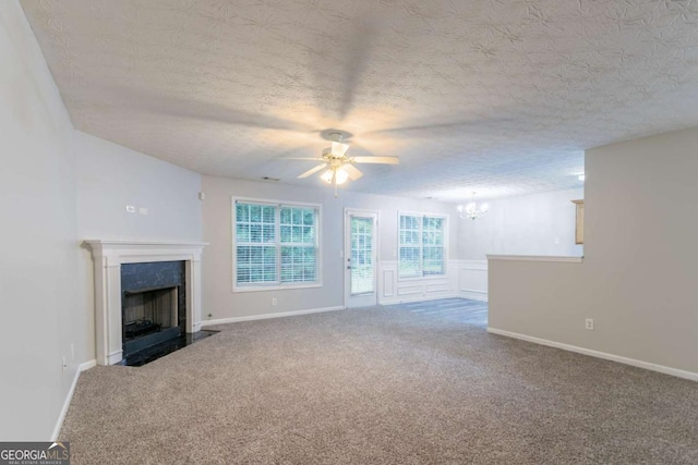 541 Shadow Valley Ct, Lithonia, GA 30058 - unfurnished living room with a chandelier, carpet, a premium fireplace, ceiling fan, and a textured ceiling