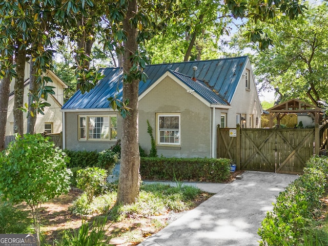 1844 Stanton St, Decatur, GA 30032 - view of front facade featuring brick siding, metal roof, a gate, and a standing seam roof