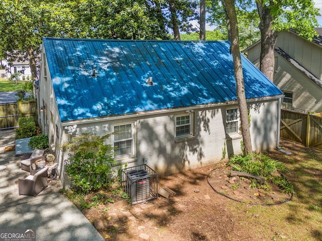 1844 Stanton St, Decatur, GA 30032 - view of property exterior with brick siding, metal roof, and central AC