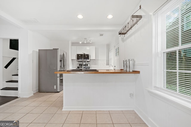 1844 Stanton St, Decatur, GA 30032 - kitchen with appliances with stainless steel finishes, light tile patterned floors, plenty of natural light, tasteful backsplash, and ornamental molding