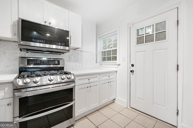 1844 Stanton St, Decatur, GA 30032 - kitchen with stainless steel appliances, light countertops, tasteful backsplash, and white cabinetry