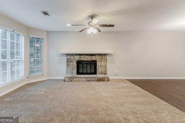 5352 Windfern Ct, Stone Mountain, GA 30088 - unfurnished living room featuring ceiling fan, baseboards, and a stone fireplace