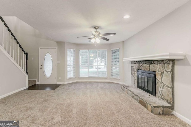 5352 Windfern Ct, Stone Mountain, GA 30088 - foyer featuring carpet, baseboards, stairway, a ceiling fan, and a stone fireplace