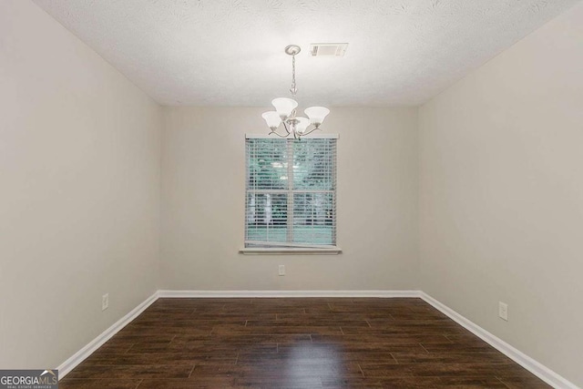 5352 Windfern Ct, Stone Mountain, GA 30088 - spare room featuring a chandelier, wood finished floors, and baseboards