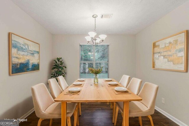 5352 Windfern Ct, Stone Mountain, GA 30088 - dining room with a chandelier, dark wood-style floors, baseboards, and a textured ceiling