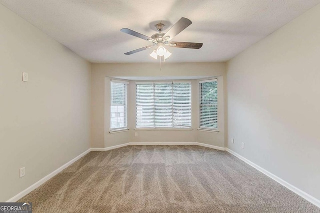 5352 Windfern Ct, Stone Mountain, GA 30088 - carpeted empty room with healthy amount of natural light, ceiling fan, baseboards, and a textured ceiling