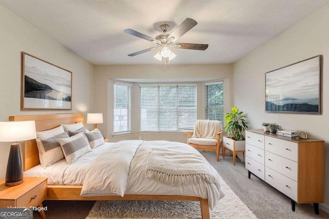 5352 Windfern Ct, Stone Mountain, GA 30088 - bedroom featuring light carpet, a textured ceiling, and ceiling fan