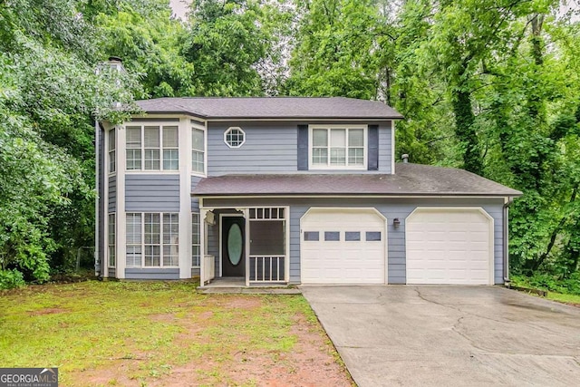 5352 Windfern Ct, Stone Mountain, GA 30088 - view of front facade with driveway, a chimney, view of scattered trees, and a front yard