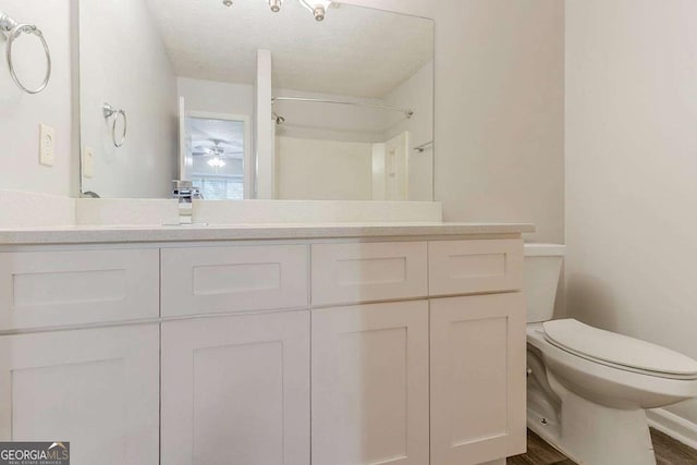 5352 Windfern Ct, Stone Mountain, GA 30088 - full bathroom with toilet, vanity, a shower, and a ceiling fan