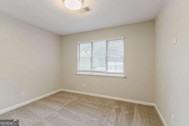 5352 Windfern Ct, Stone Mountain, GA 30088 - carpeted empty room featuring baseboards and a textured ceiling