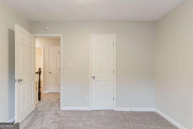 5352 Windfern Ct, Stone Mountain, GA 30088 - unfurnished bedroom featuring light carpet and baseboards