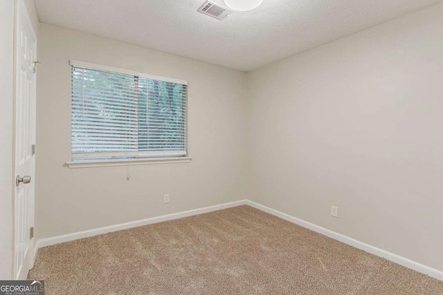5352 Windfern Ct, Stone Mountain, GA 30088 - spare room featuring carpet flooring, a textured ceiling, and baseboards